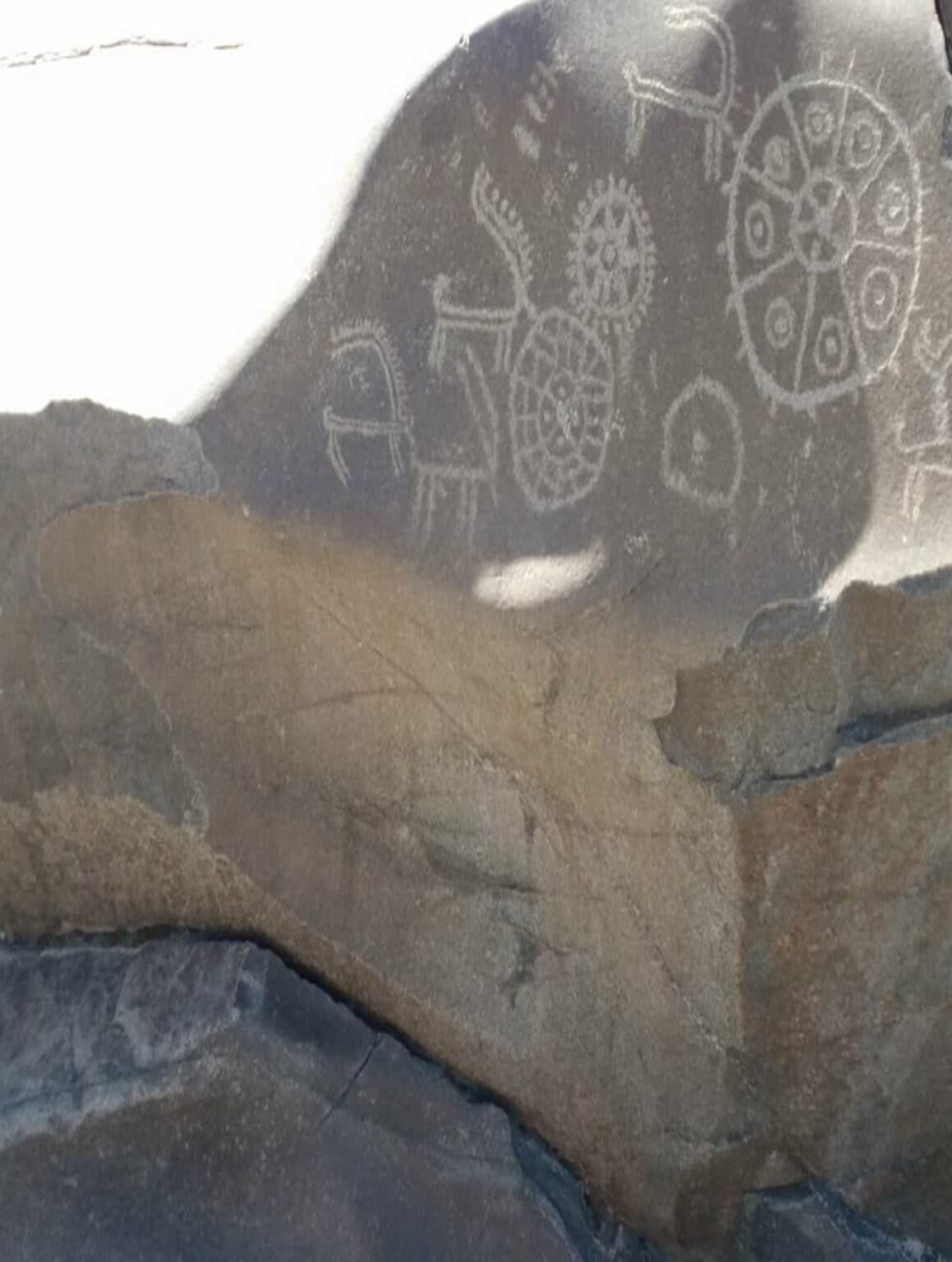 Ancient petroglyphs carved into a rock face in Gilgit-Baltistan