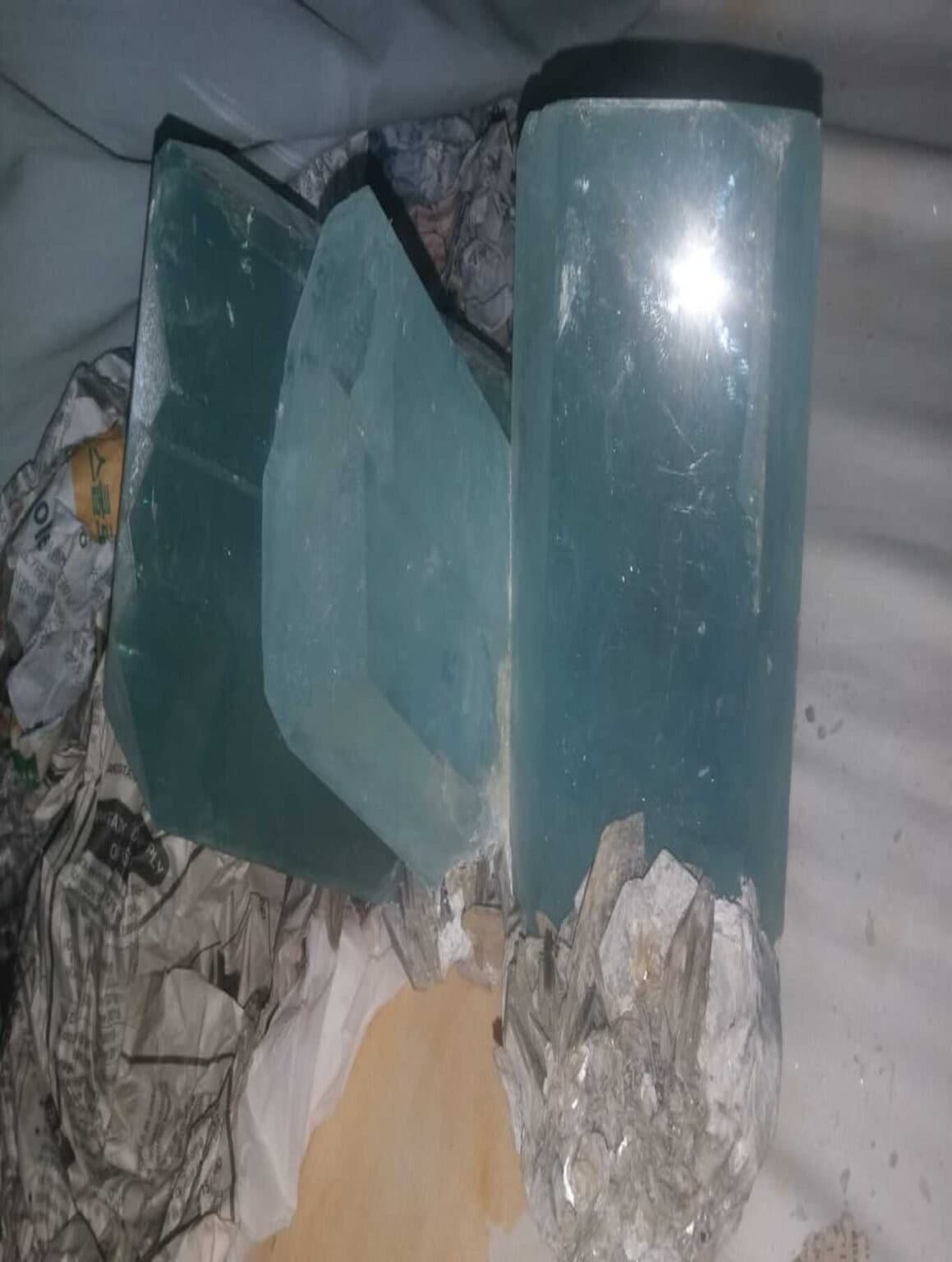 Large aquamarine crystals partially wrapped for transport