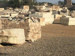 Rows of quarried marble blocks in an open stone yard