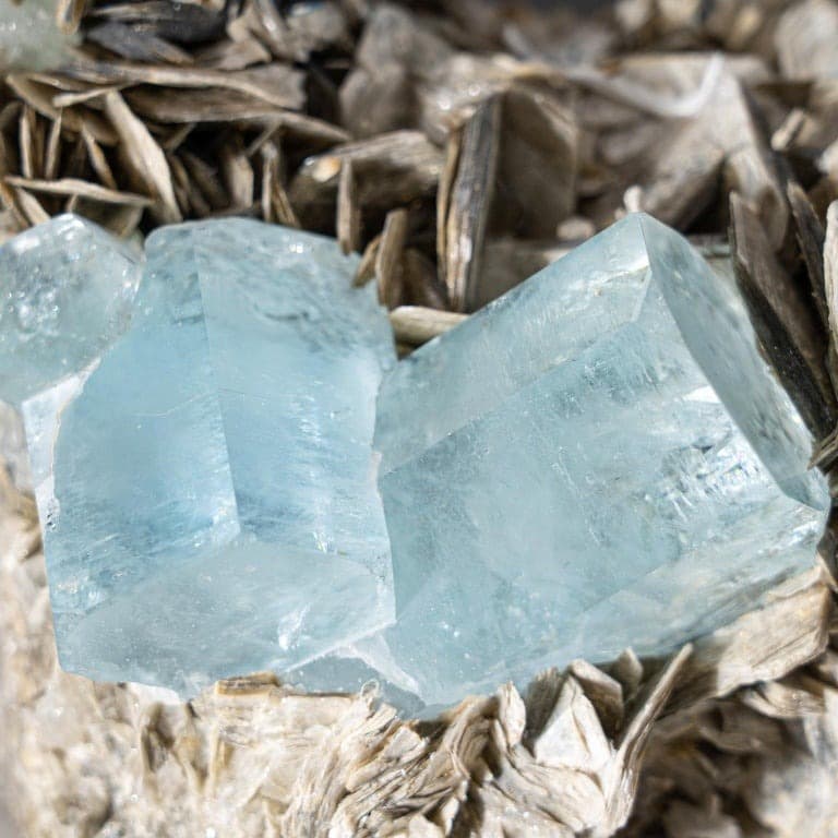 Raw aquamarine crystal cluster on matrix rock
